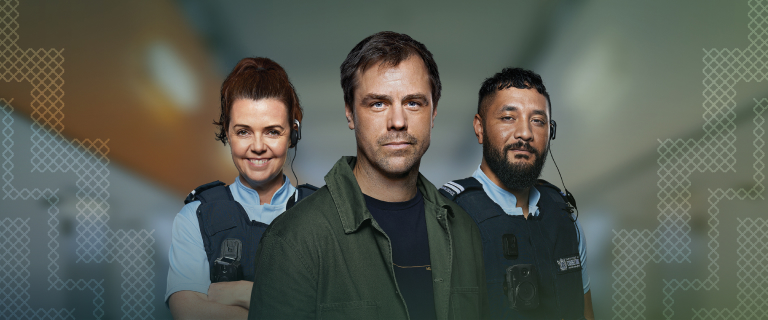 Ryan Wolf stands with Sililo and Tina, the Corrections Officers portrayed in the Stories from the Inside campaign